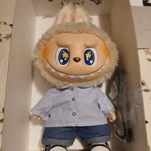 Charming Plush Creature with Striped Blue Shirt